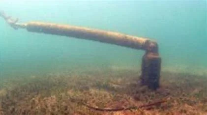 Underwater mooring chain inspection showing rust and marine growth